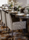 Brown formal dining room chairs with gold leg caps and ornate dining accessories